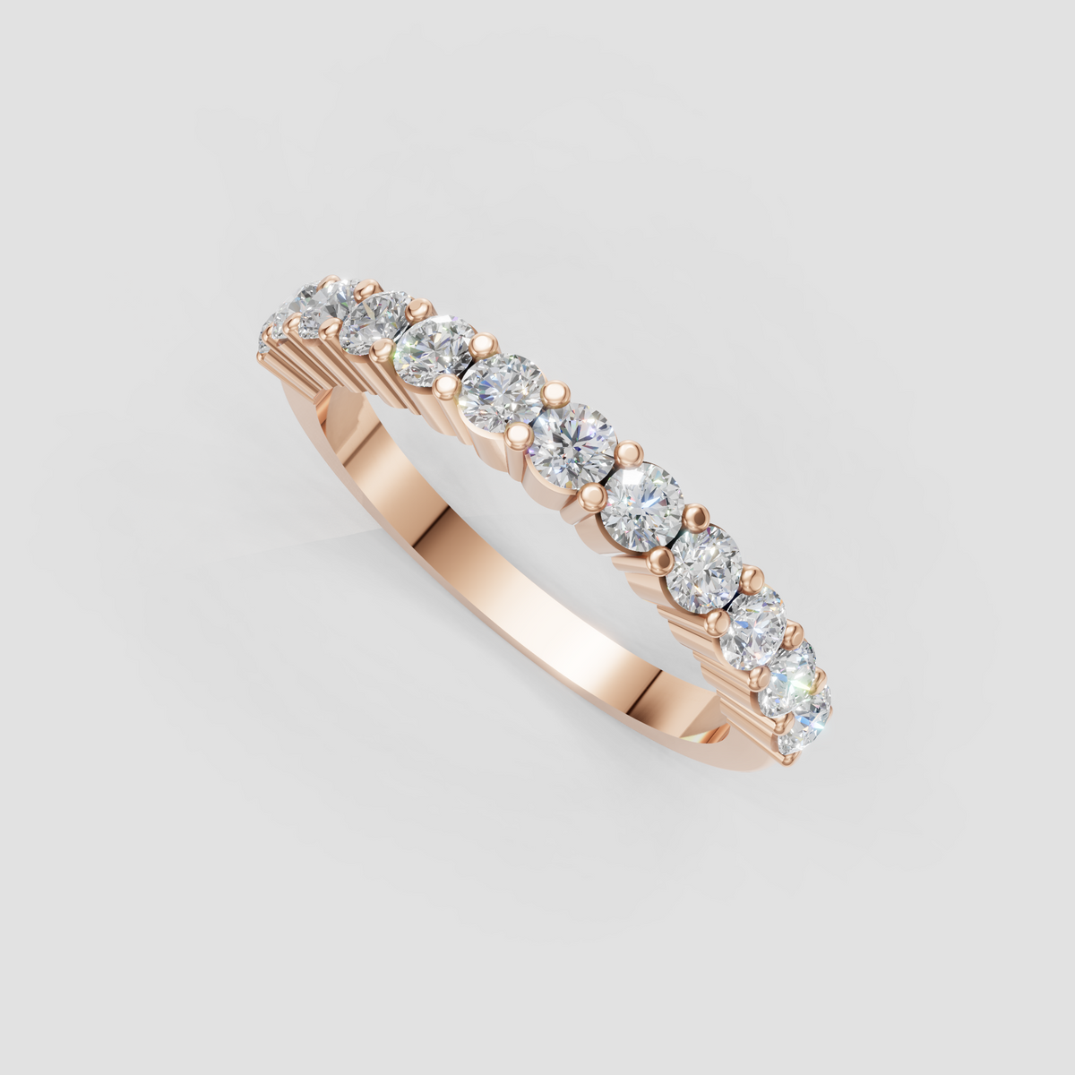 Round cut diamond eternity ring with delicate rounded gold prongs between stones