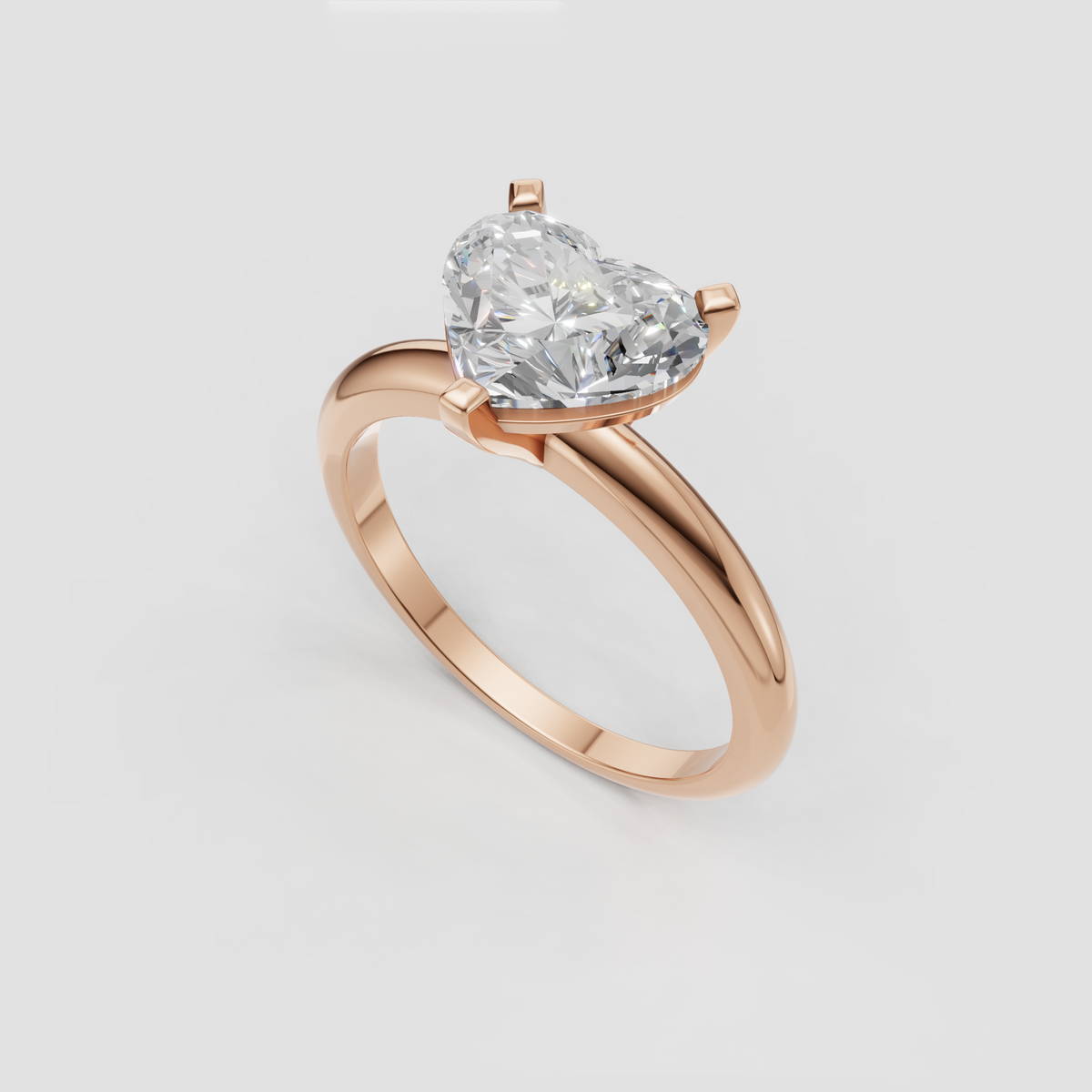 Heart shaped center diamond secured by three rounded gold prongs