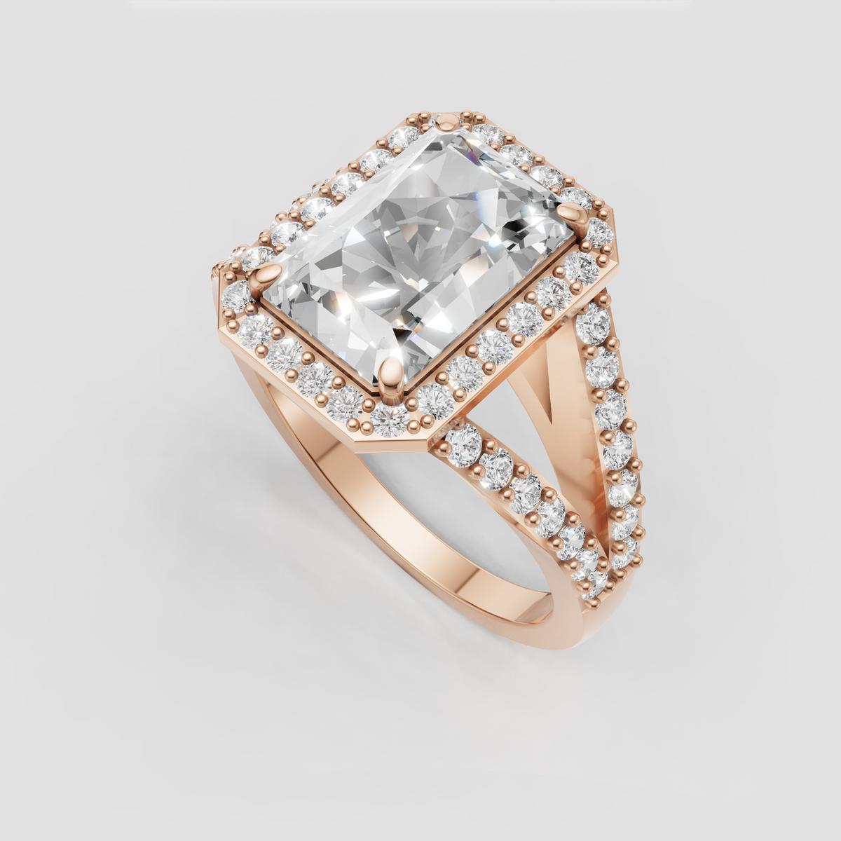 Radiant cut diamond solitaire surrounded by a pave halo