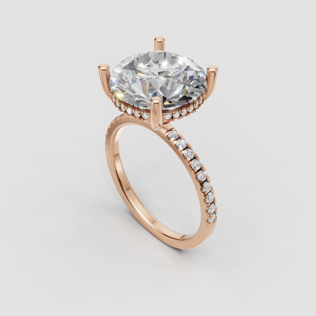 Front view of round cut diamond engagement ring with four-prong setting and sparkling pavé shoulders.