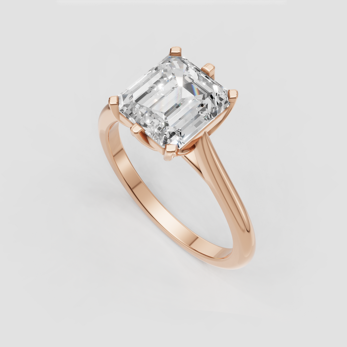 Emerald cut solitaire diamond ring with elegant cathedral shoulders