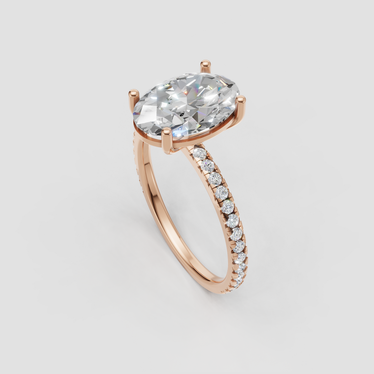 Side view of oval diamond cathedral engagement ring in yellow gold