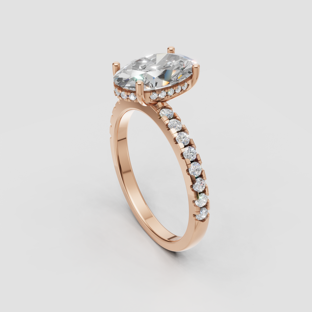 Yellow gold cathedral ring featuring a pear cut diamond and diamond pavé band