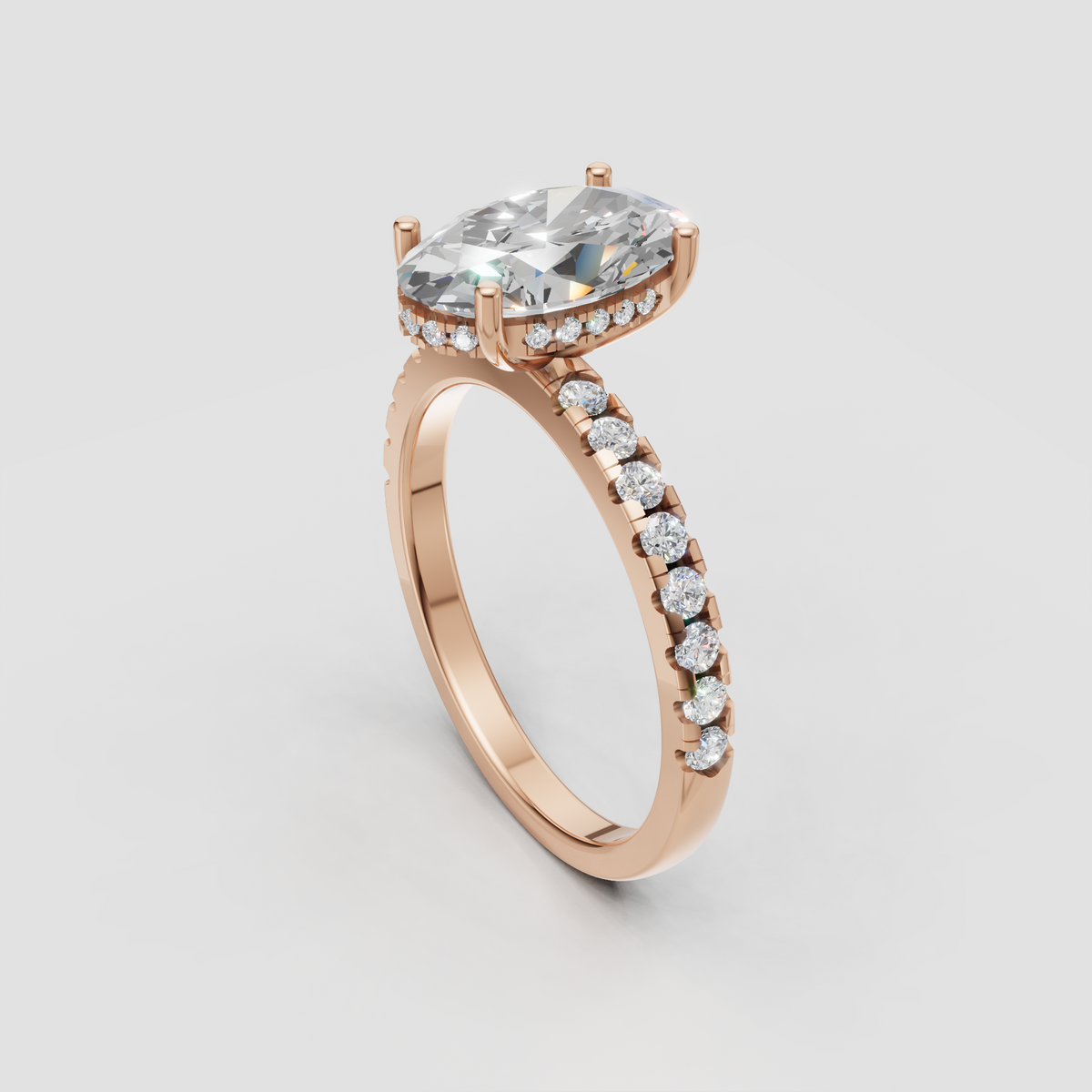 Yellow gold cathedral ring featuring a pear cut diamond and diamond pavé band