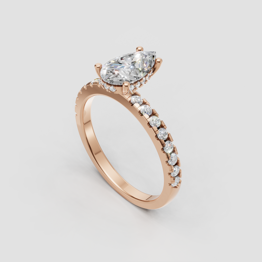 Side view of pear diamond hidden halo engagement ring in yellow gold