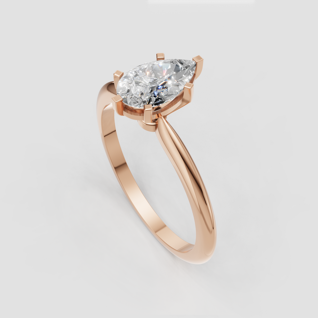 Polished yellow gold ring featuring a pear shaped center diamond