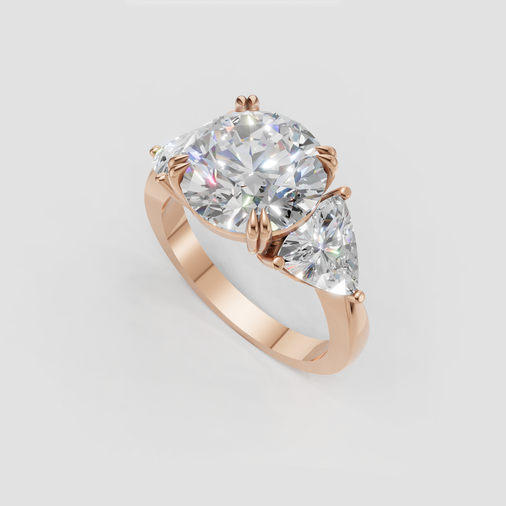 Yellow gold three stone diamond ring with round center and pear side accents