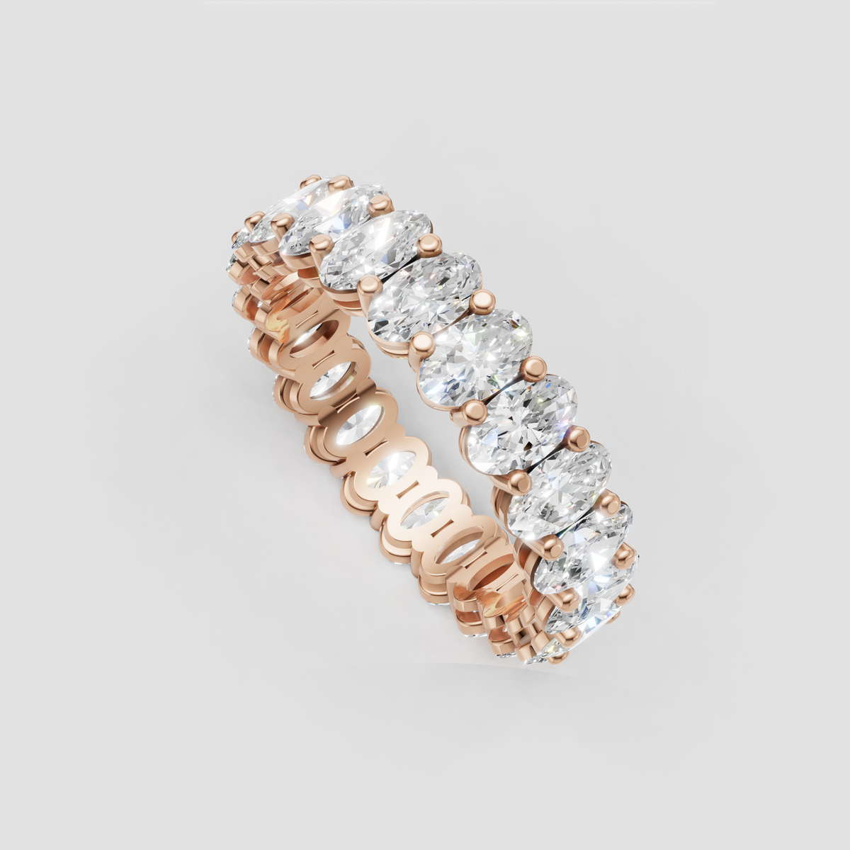 Yellow gold eternity band featuring oval cut diamonds