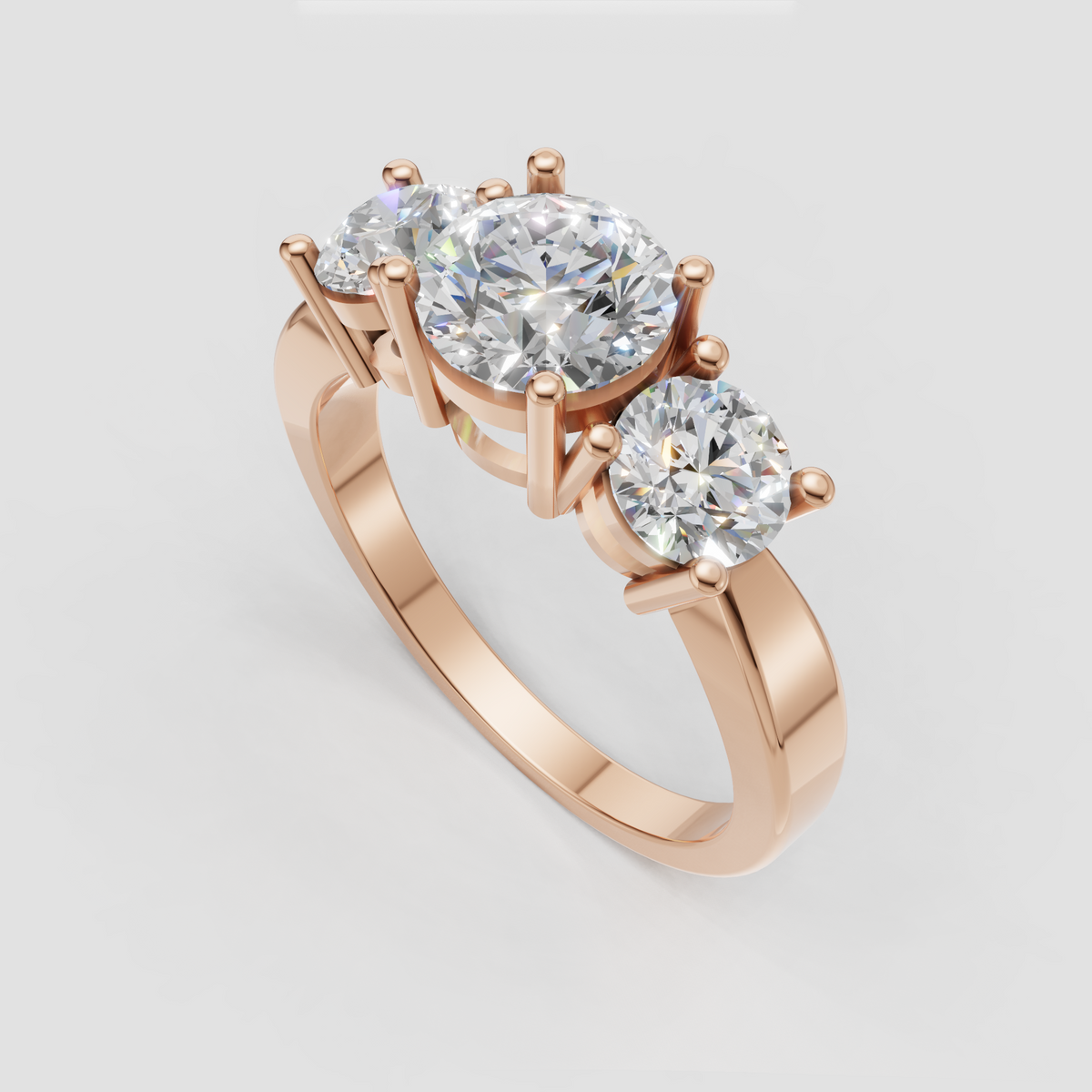 Prong set round diamond three-stone engagement ring