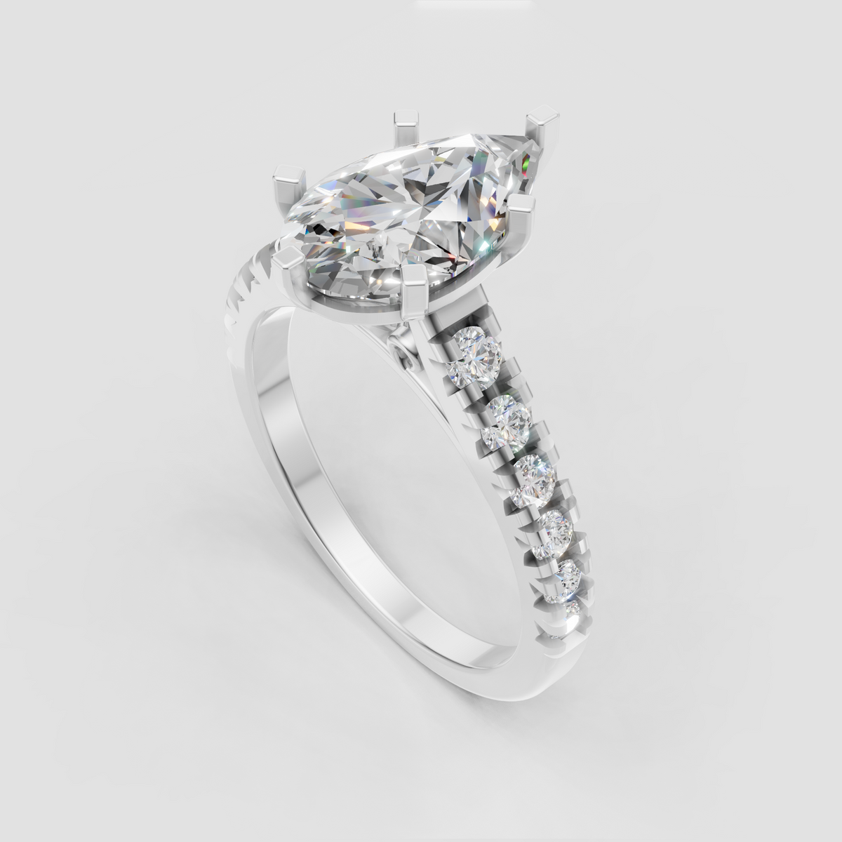Close-up pear shaped diamond ring showcasing six-prong center setting and cathedral-style pavé shoulders.