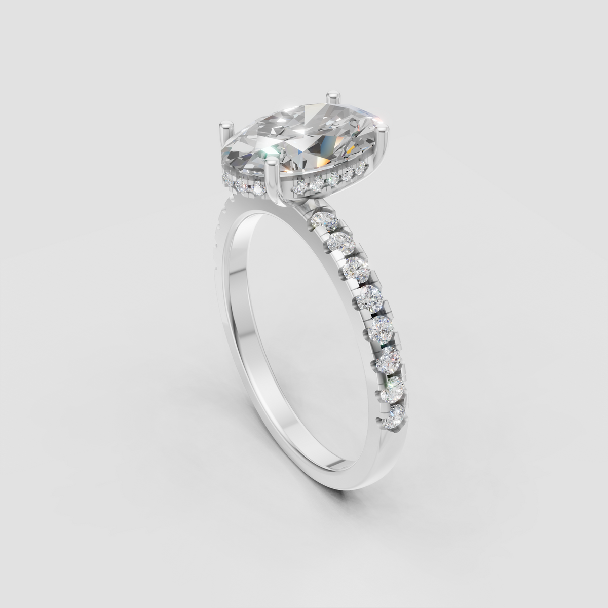 Luxury pear cut engagement ring with pavé diamond shoulders in yellow gold