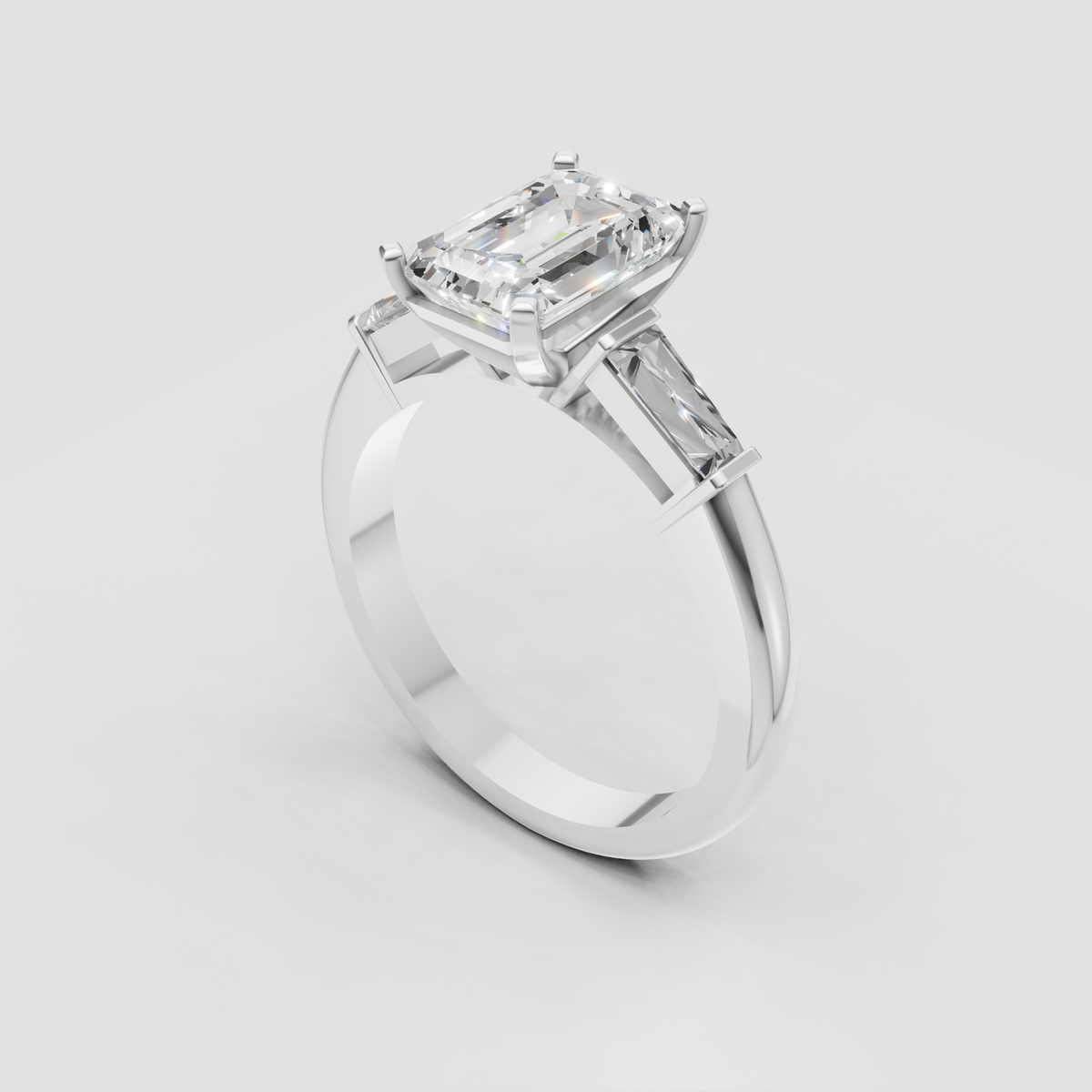 Emerald cut diamond engagement ring featuring tapered baguette accents
