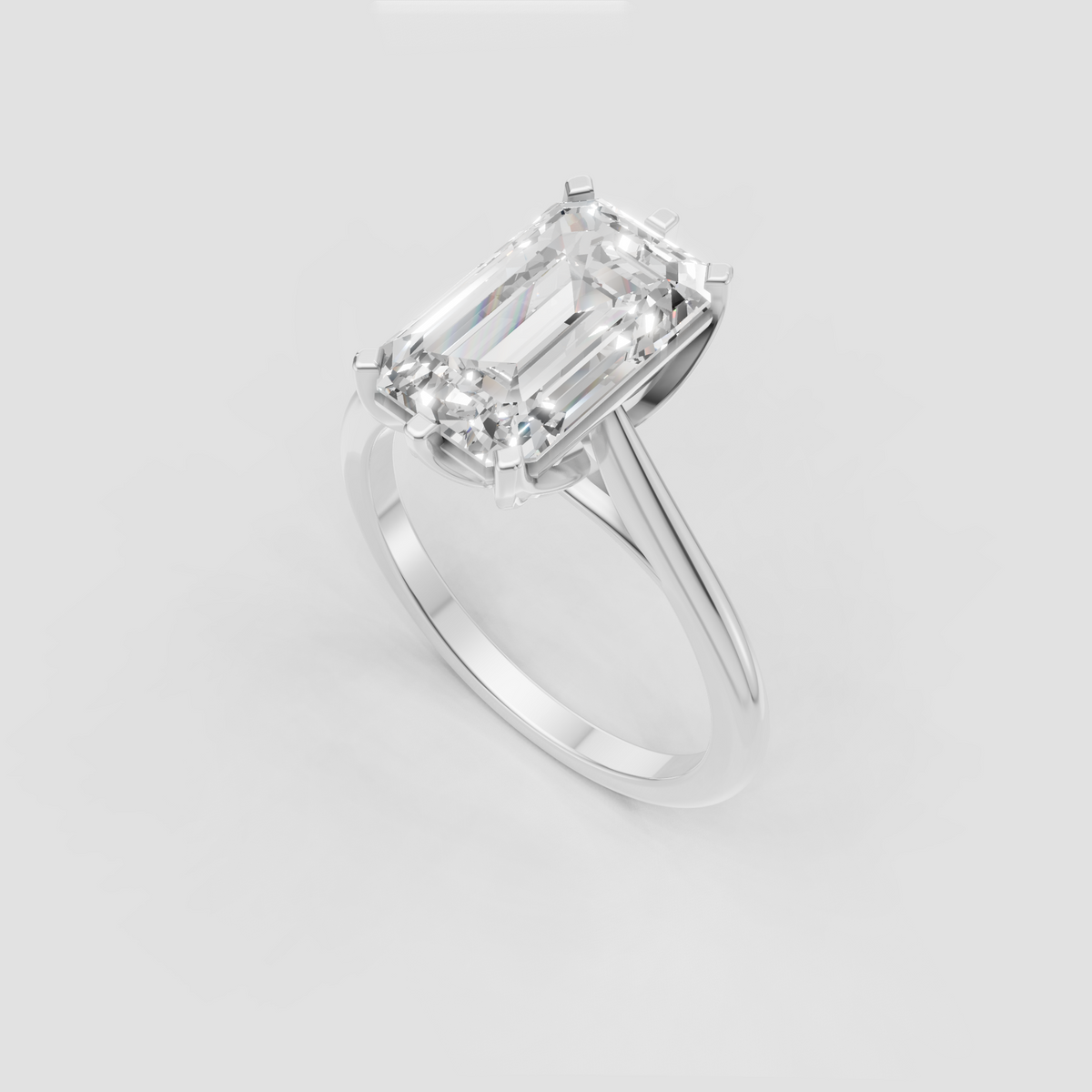 Step cut emerald diamond solitaire ring in yellow gold