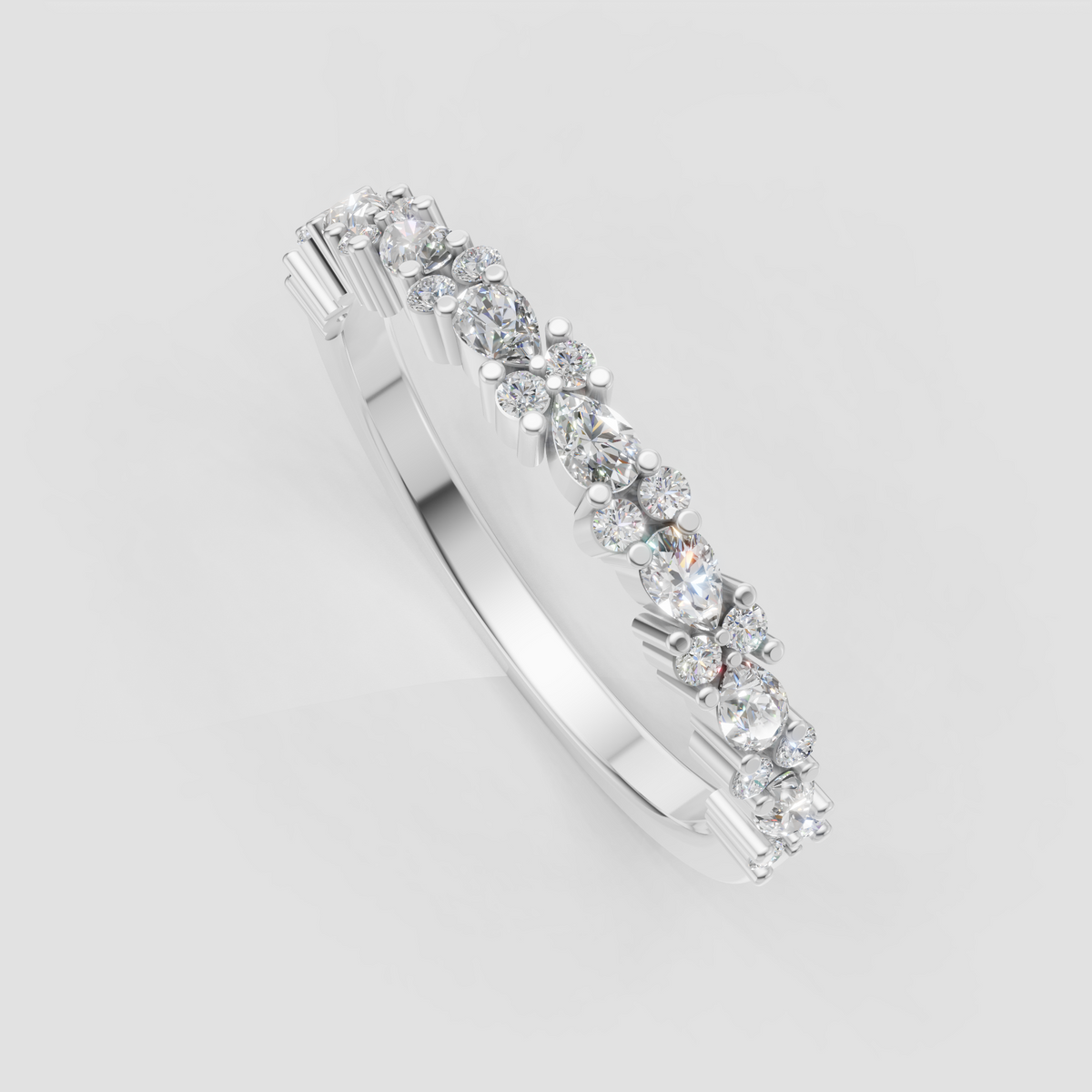 Mixed shape diamond half eternity band featuring round and pear stones