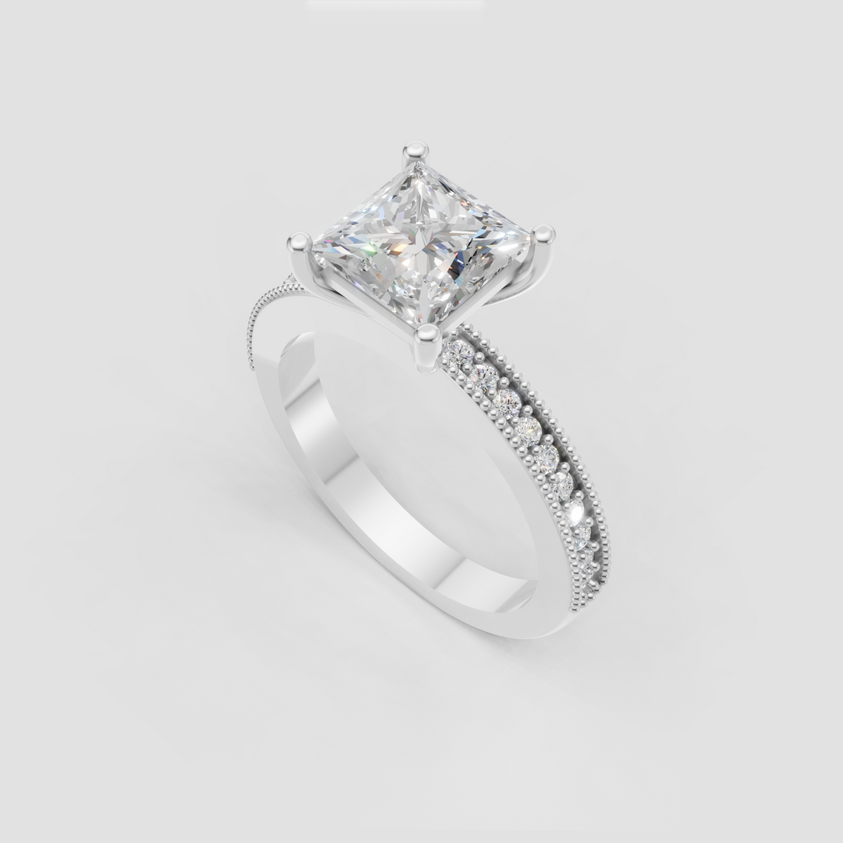 Elegant princess-cut engagement ring with four-prong setting and pavé accents