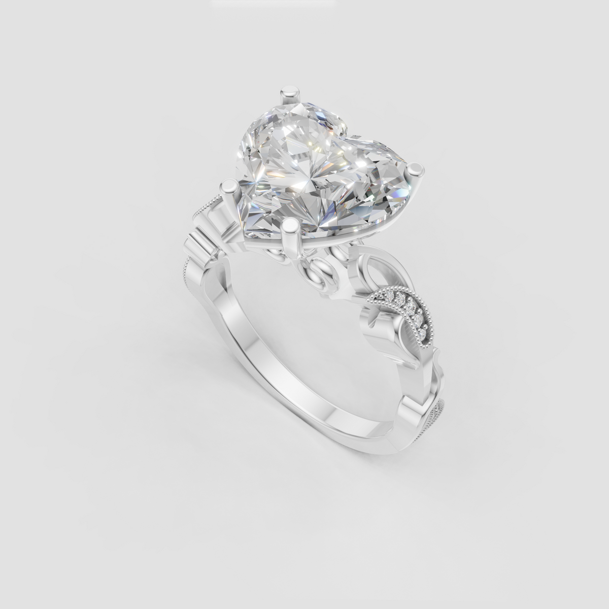 Heart cut diamond ring featuring ornate pavé side stones