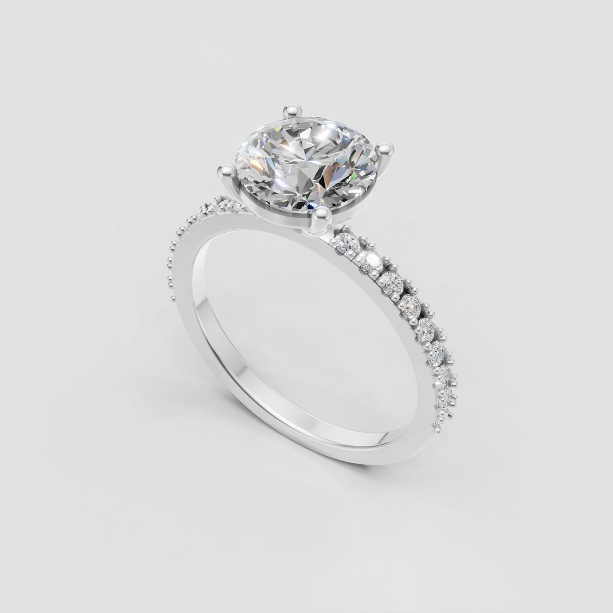 Four-prong oval diamond ring with half-eternity pave band