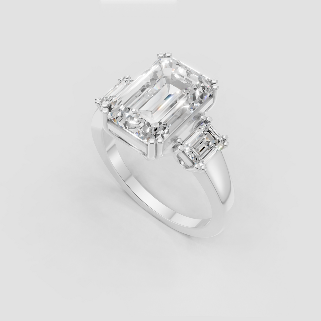 Luxury emerald cut three stone engagement ring in yellow gold