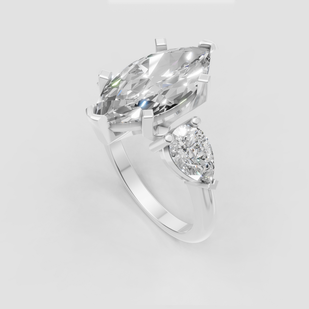 Three stone engagement ring featuring marquise and pear diamonds