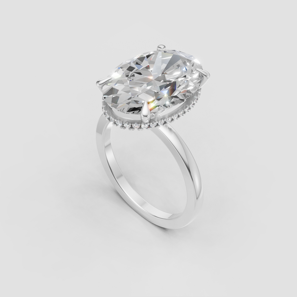Elongated oval diamond center stone in a gold prong setting