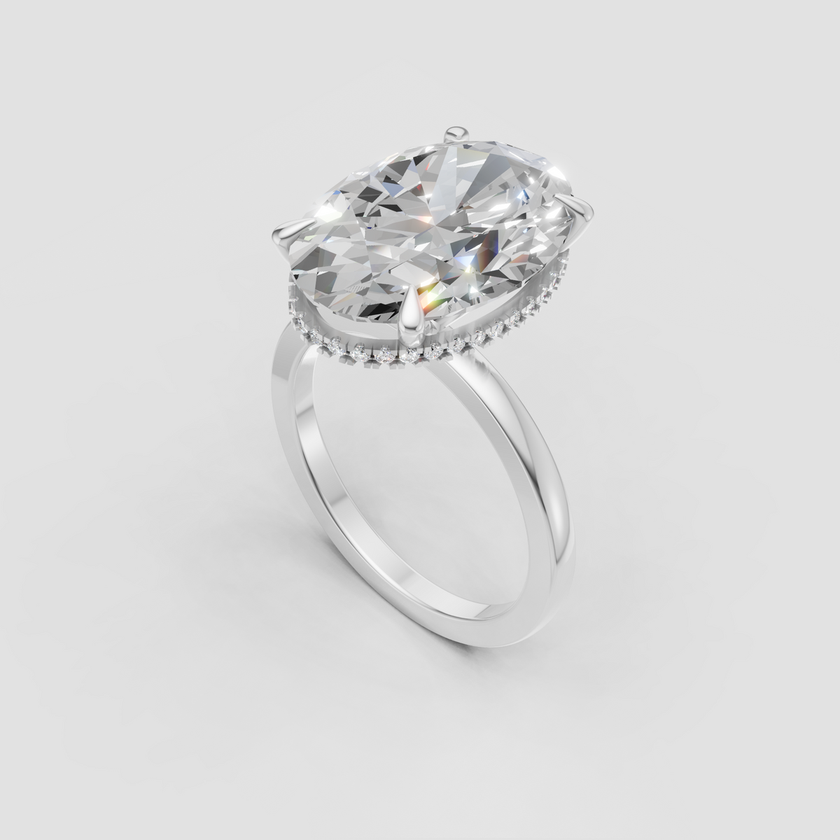 Elongated oval diamond center stone in a gold prong setting