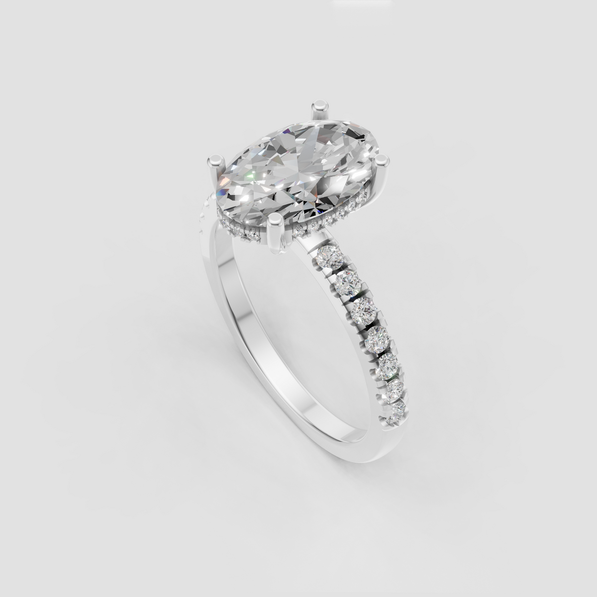 Oval diamond ring featuring hidden halo and sparkling pavé shoulders