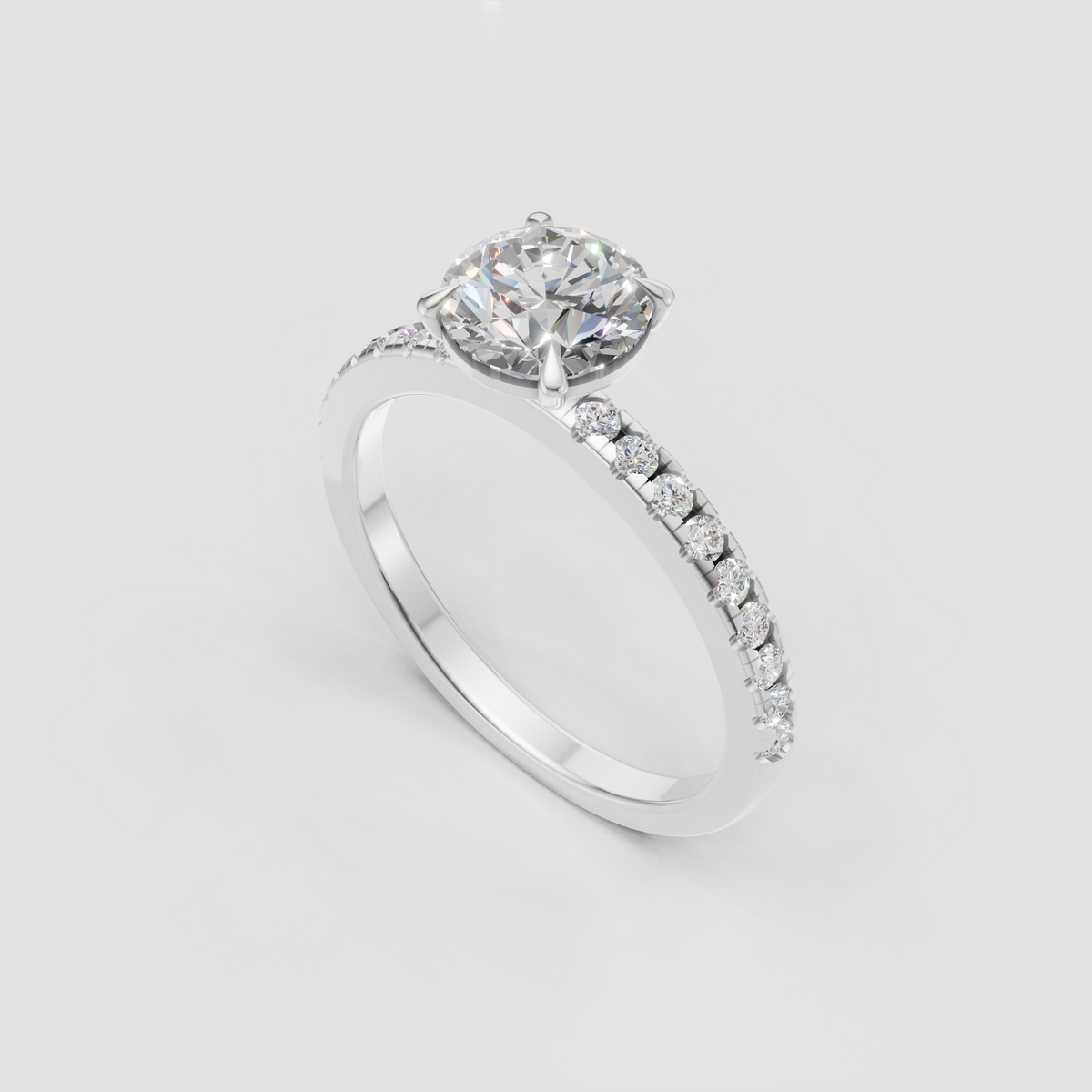 Round Diamond engagement ring with four-prong setting and delicate pavé shoulders