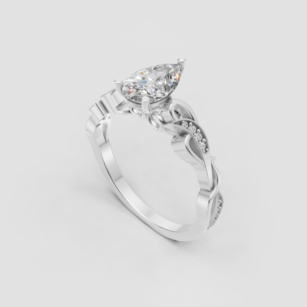 Ornate yellow gold engagement ring featuring a pear cut diamond