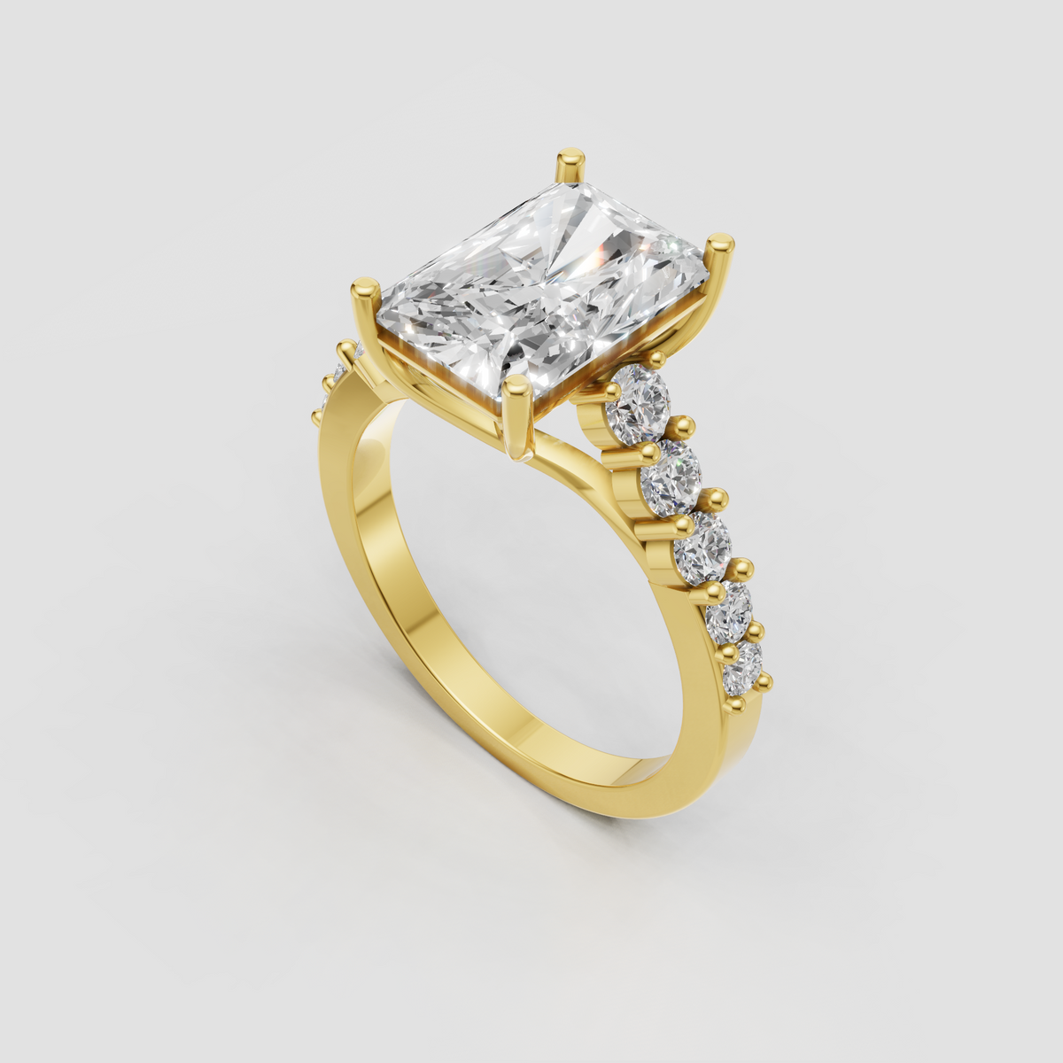 Radiant cut diamond ring with four-prong setting and round side stones