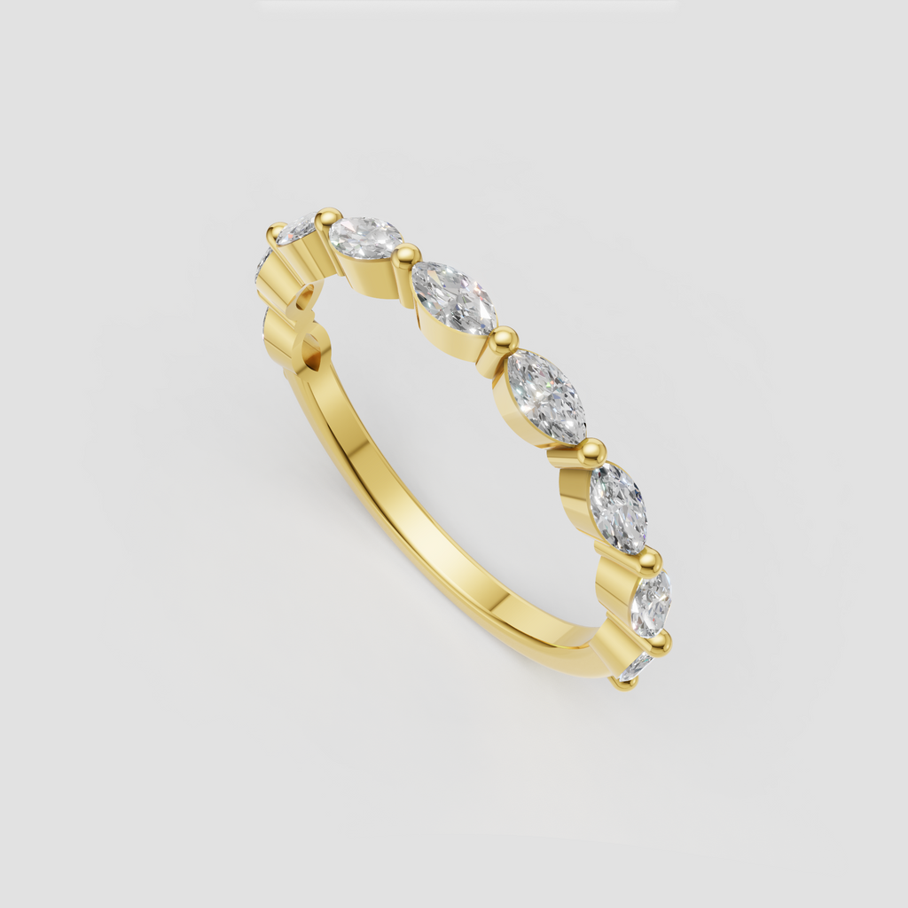 Marquise diamond bezel set eternity band in polished yellow gold