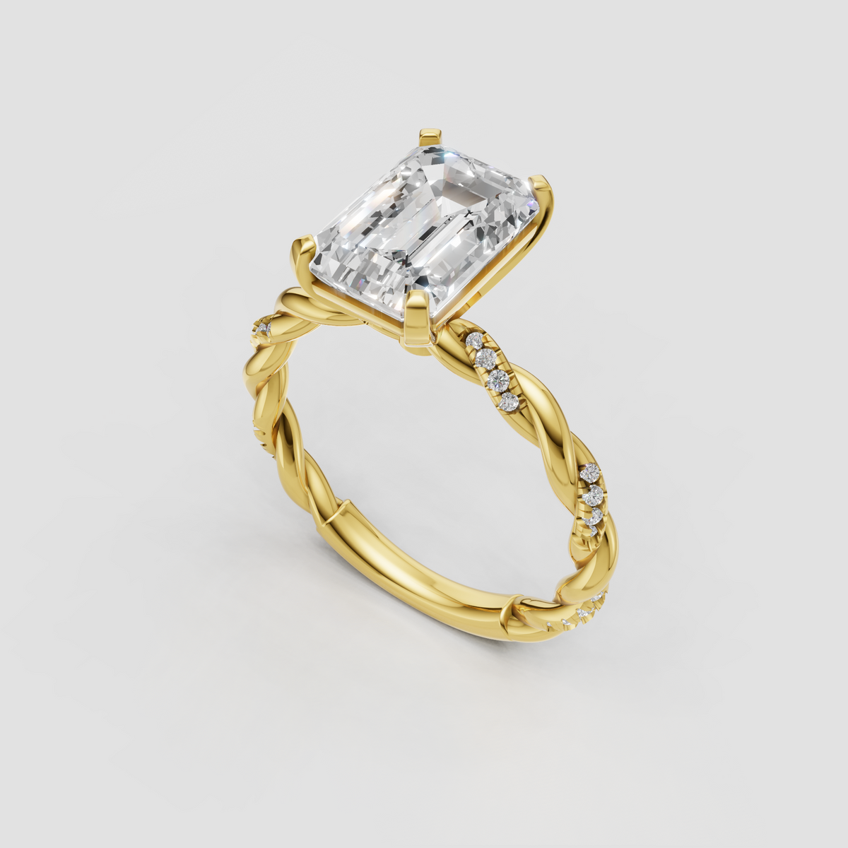 Yellow gold emerald cut diamond ring with intricate twisted band
