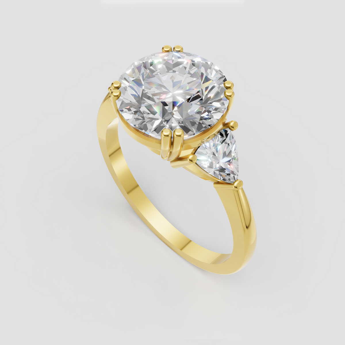 Round brilliant diamond ring with pear-shaped side stones