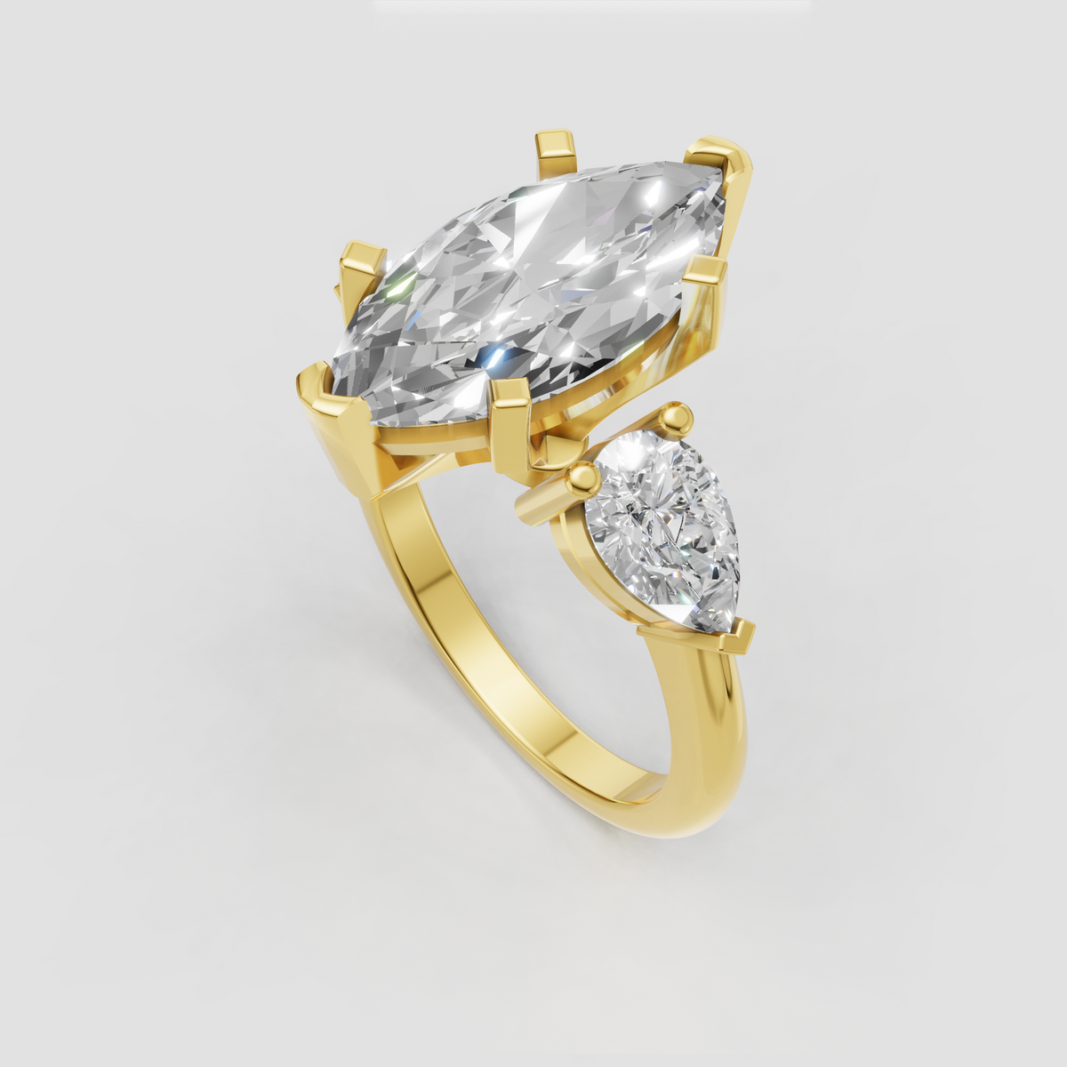 Marquise diamond ring with pear shaped side stones in prong setting