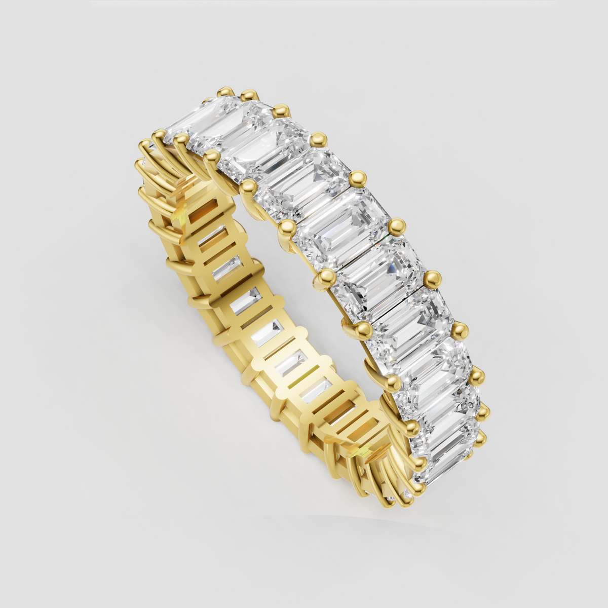 Emerald cut diamond eternity ring with gold prong setting