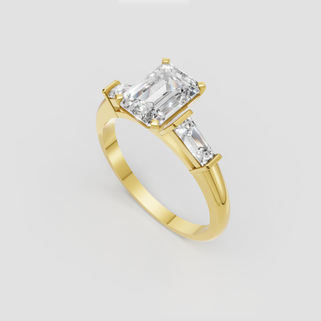 Emerald cut engagement ring with baguette side stones and yellow gold band