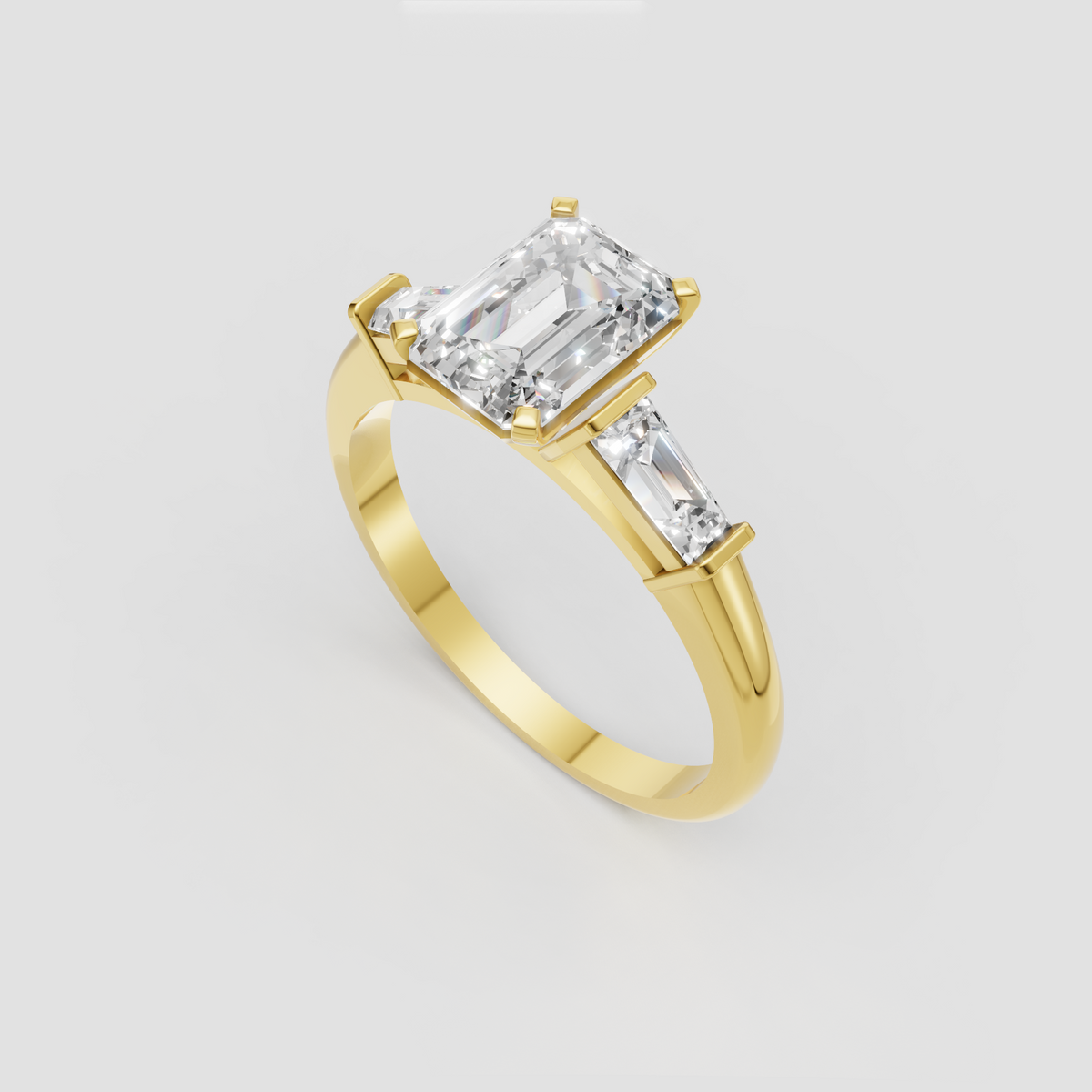 Emerald cut engagement ring with baguette side stones and yellow gold band