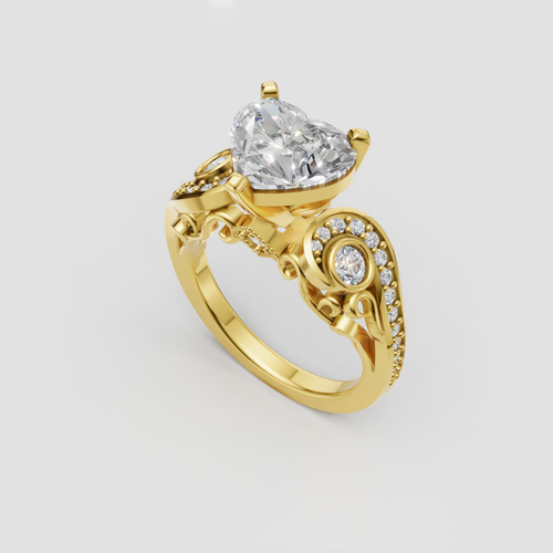 Yellow gold heart diamond ring with prong setting and ornate scrollwork