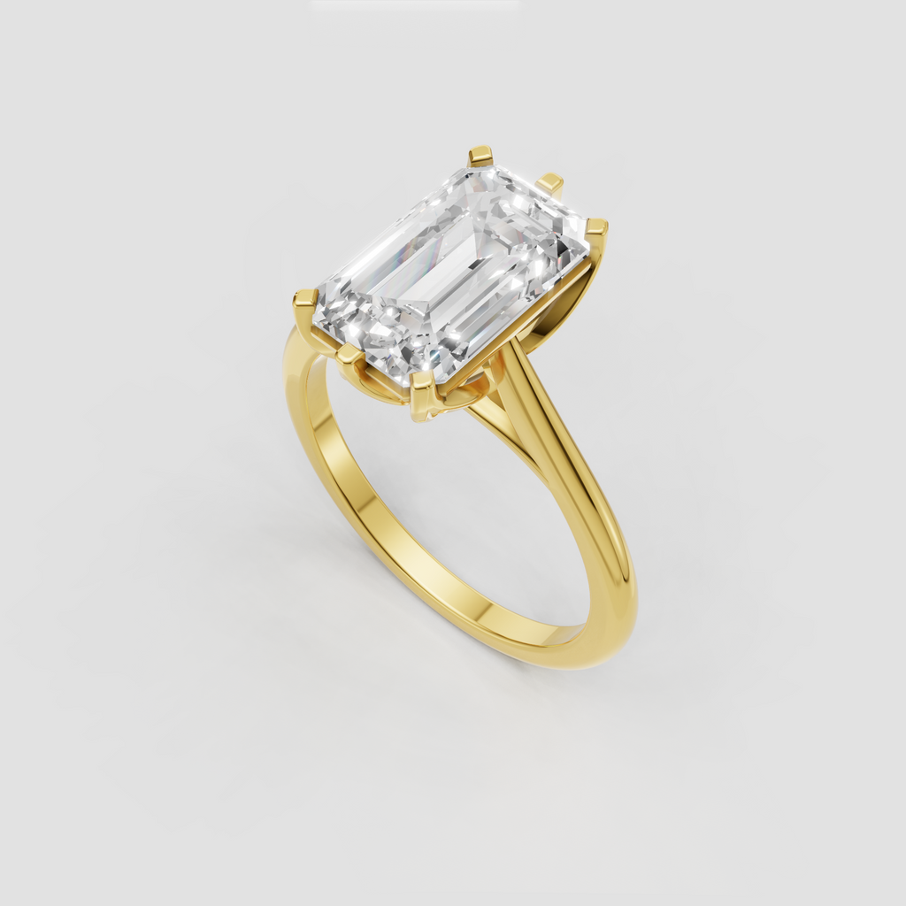 Emerald cut engagement ring with sculptural twisted shoulders