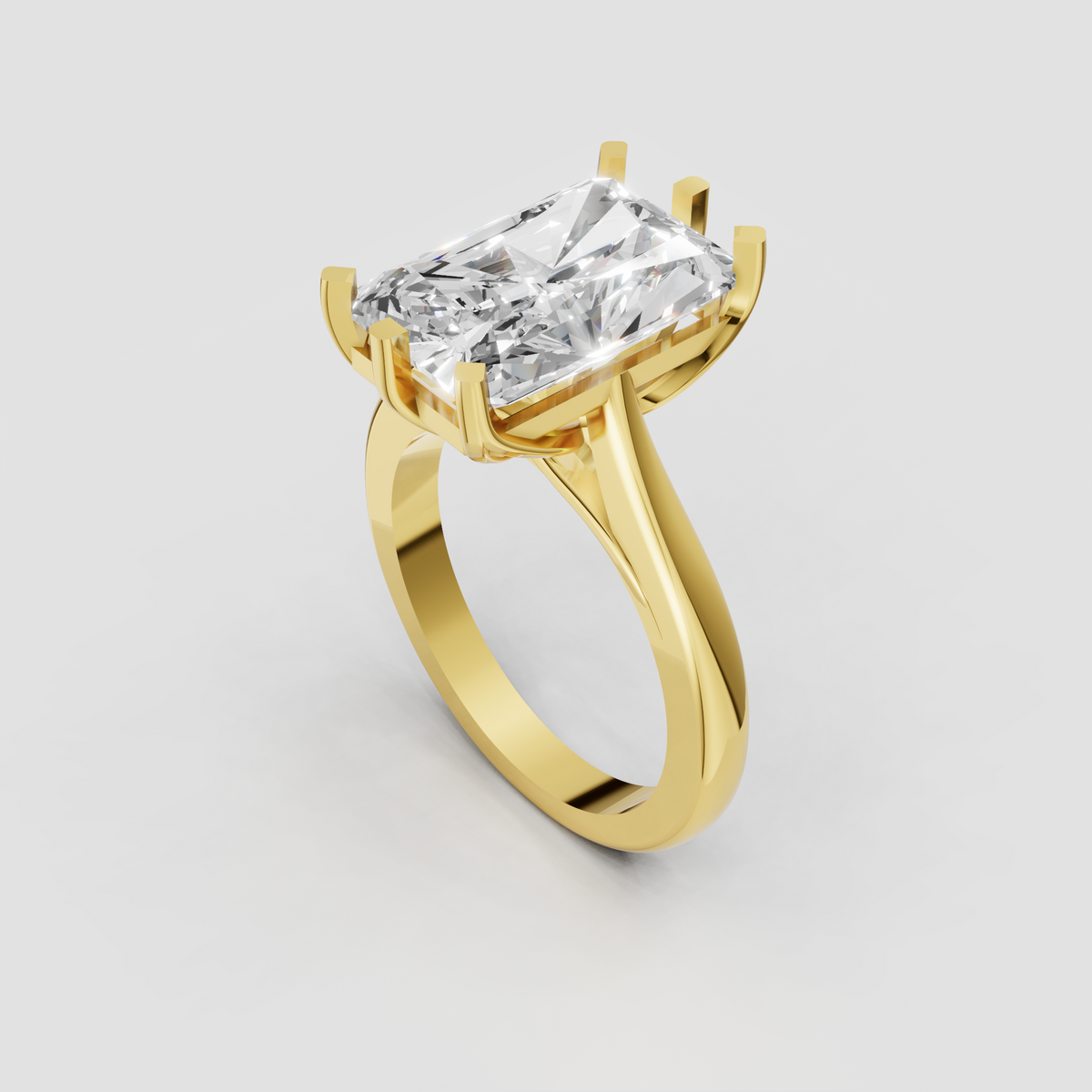 Yellow gold radiant-cut solitaire engagement ring with sculptural twisted shoulders