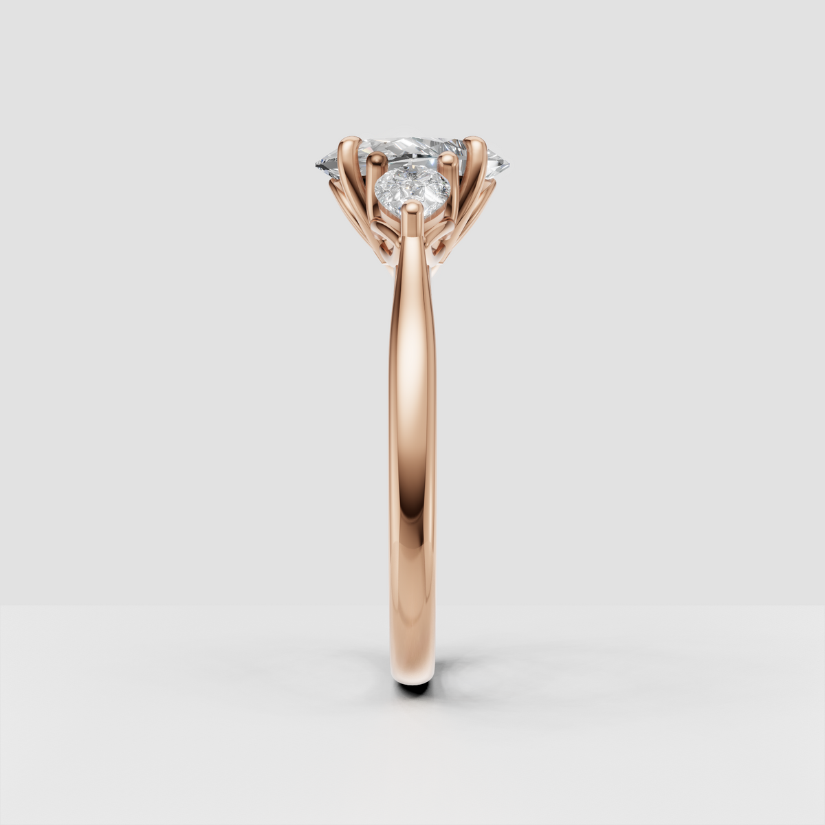 Yellow gold three-stone engagement ring with oval center diamond