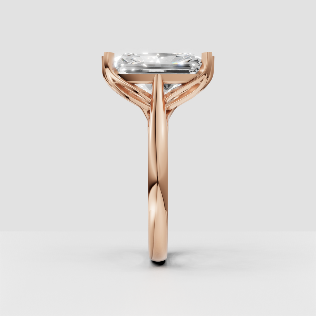 Side view of radiant-cut solitaire engagement ring with open gallery detailing