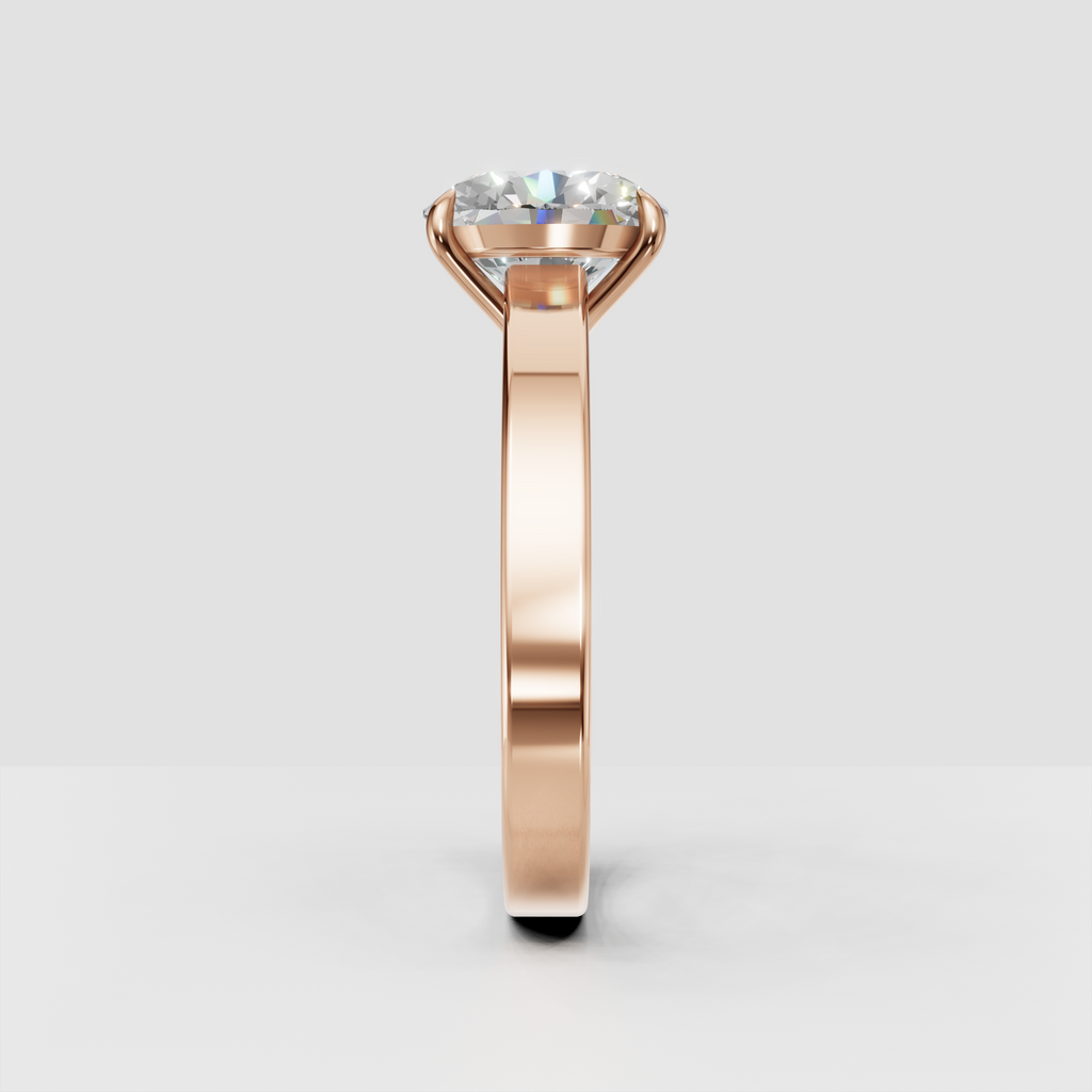 Simple oval diamond engagement ring in yellow gold