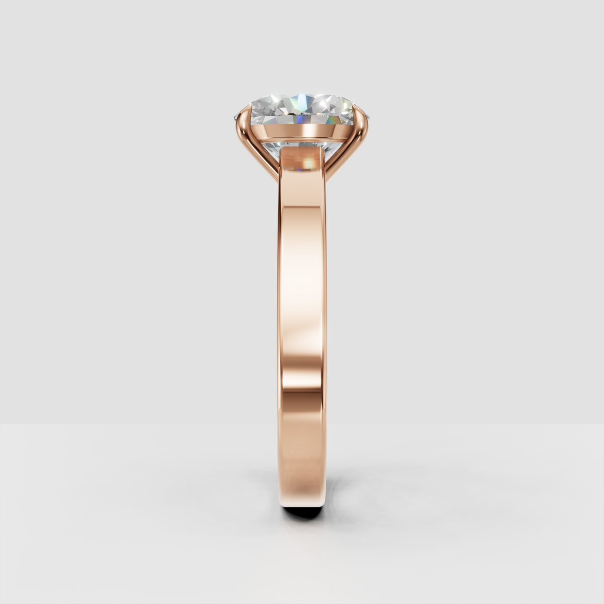 Simple oval diamond engagement ring in yellow gold