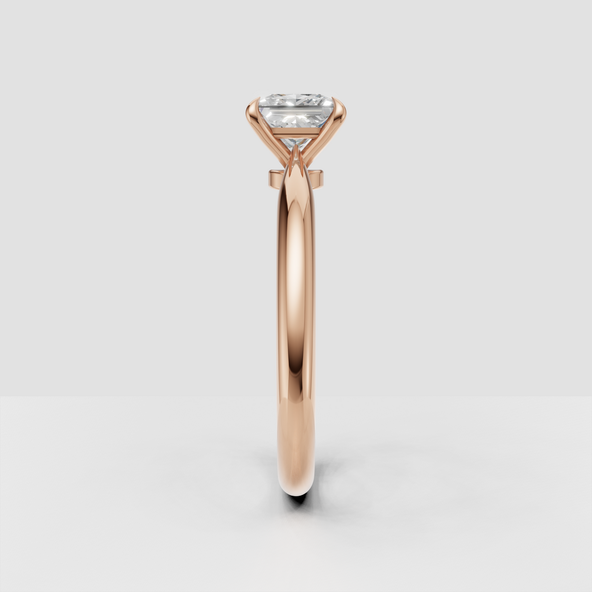 Princess cut solitaire engagement ring with sculpted yellow gold band