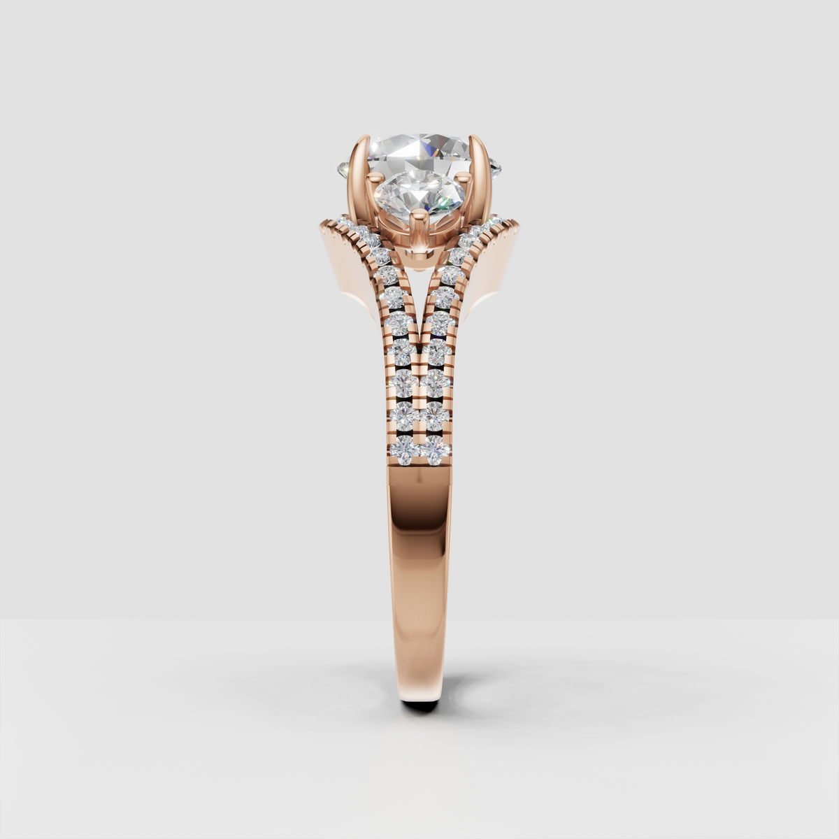 Round diamond ring featuring sculpted four prong setting