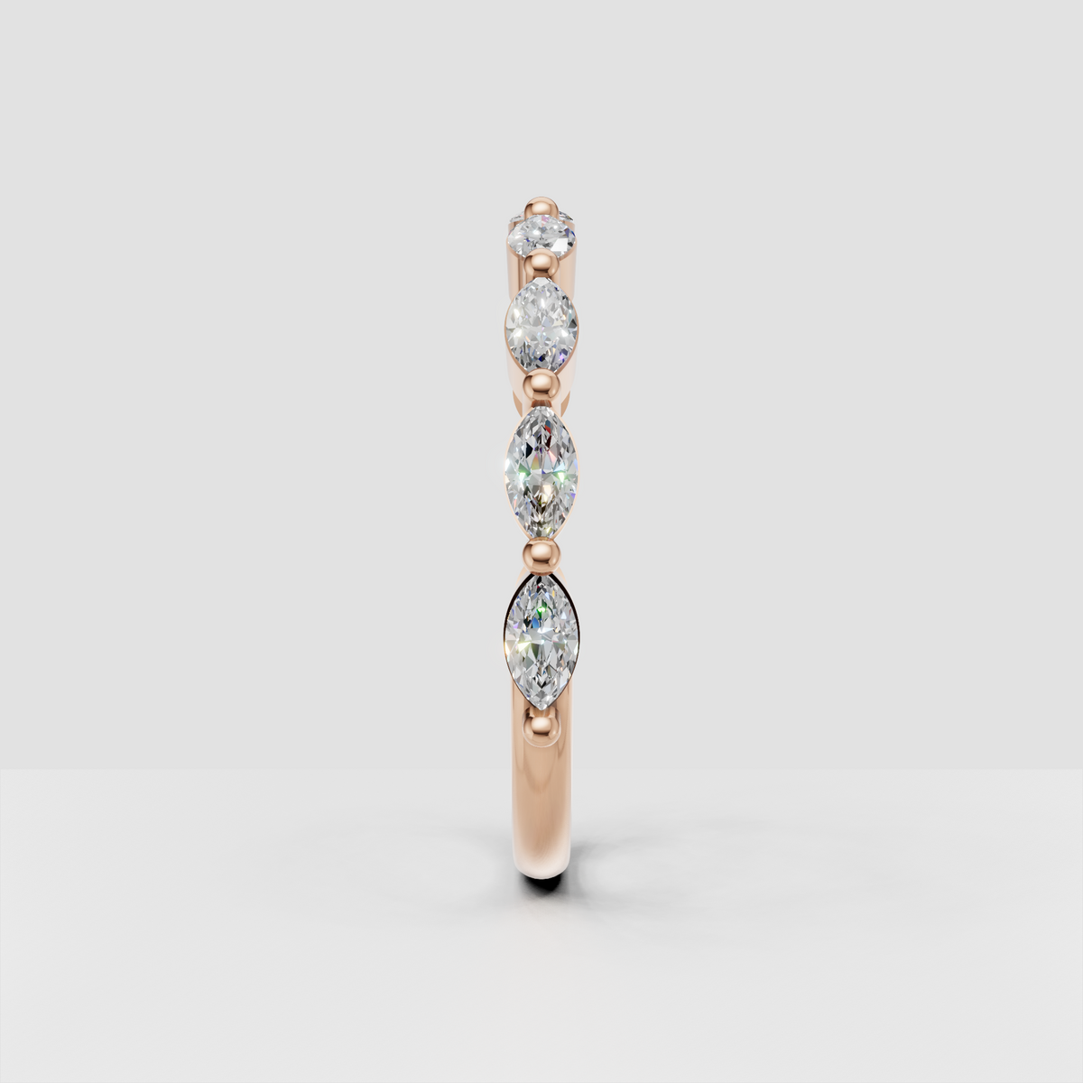 Close-up of marquise and round diamonds in a yellow gold band