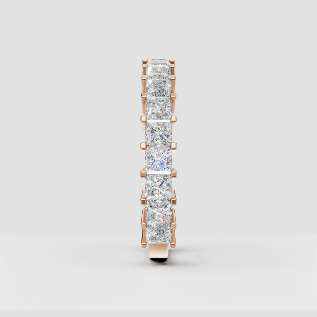 Yellow gold eternity ring featuring cushion cut diamonds