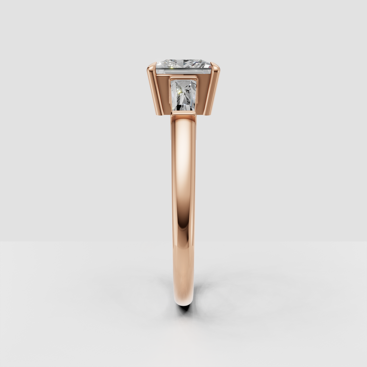 Contemporary three stone diamond engagement ring with baguette side stones