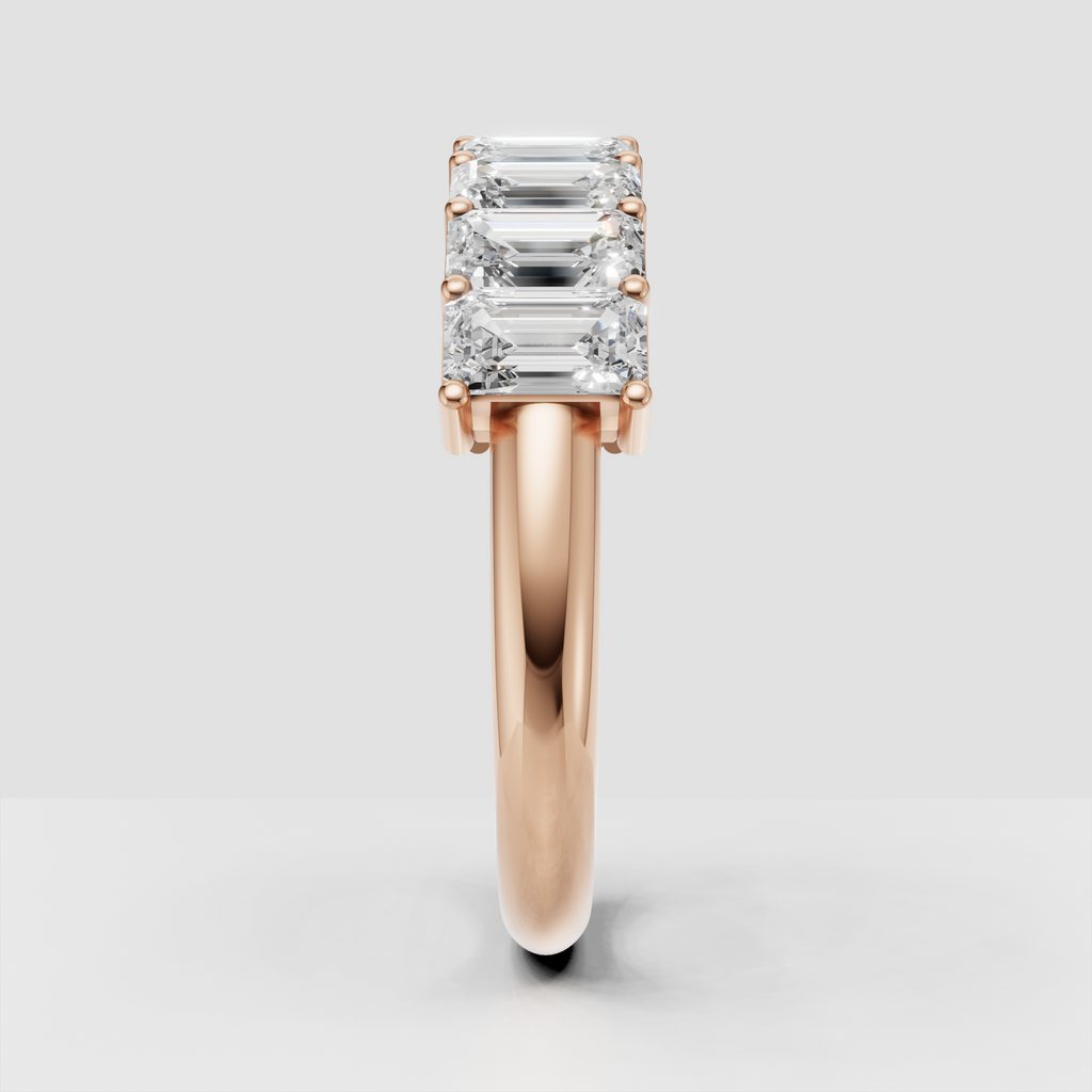Emerald cut diamond band with refined yellow gold setting