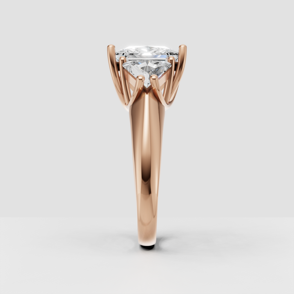 Close-up of princess cut three stone diamond engagement ring